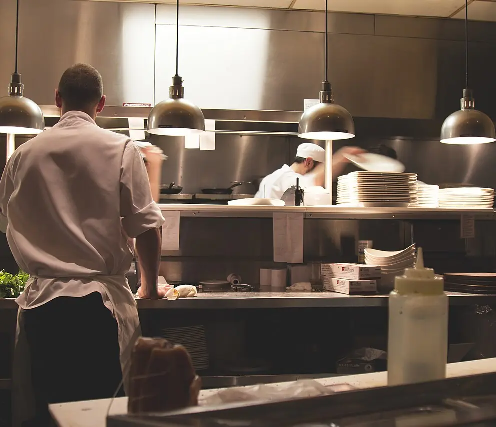Cooks working the line in a busy restaurant kitchen
