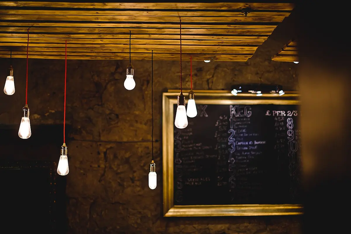 A chalkboard menu under hanging light bulbs
